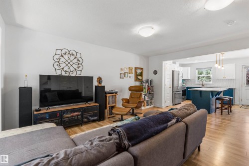 Light wood-finish flooring throughout, white walls, recessed lighting, and an open-concept design - #71 330 Bulyea Rd Nw, Edmonton, AB 
