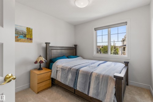 Neutral wall paint, plush carpet flooring, and a window with a grid pattern - #71 330 Bulyea Rd Nw, Edmonton, AB 