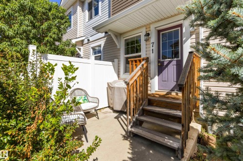 Private patio area with concrete flooring, white privacy fencing, and mature perimeter landscaping - #71 330 Bulyea Rd Nw, Edmonton, AB 