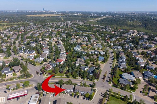 Aerial perspective showcasing a residential neighborhood with a distant cityscape - #71 330 Bulyea Rd Nw, Edmonton, AB 