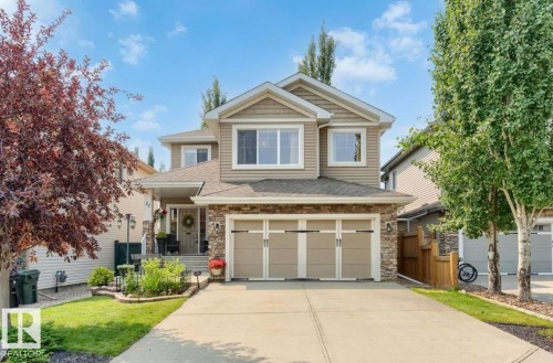 Two-story residence featuring a stone and siding facade, a two-car garage, and a concrete driveway - 22 Voleta Crest, Spruce Grove, AB 