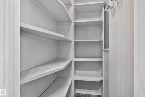 Built-in shelving with multiple levels, painted white finishes, and a corner configuration - 13803 130A Avenue Nw, Edmonton, AB 