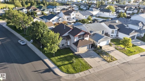 Corner lot residence featuring a two-car garage, concrete driveway, and mature landscaping - 13803 130A Avenue Nw, Edmonton, AB 