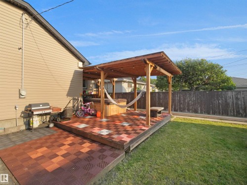 Covered patio with wood-finish posts and a shingled roof - 13338 131 Street Nw, Edmonton, AB 