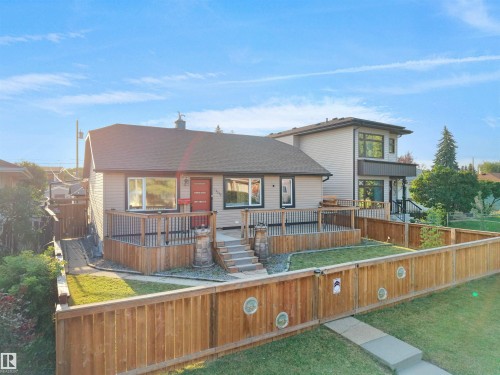 Single-story residence featuring light-colored siding and a dark-shingled roof - 13338 131 Street Nw, Edmonton, AB 