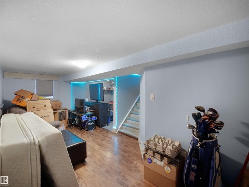 Wood-finish flooring, recessed lighting, and a window with blinds - 13338 131 Street Nw, Edmonton, AB 