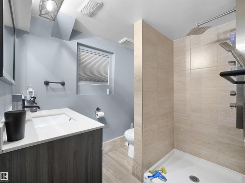 Modern vanity with an integrated sink and white countertop - 13338 131 Street Nw, Edmonton, AB 