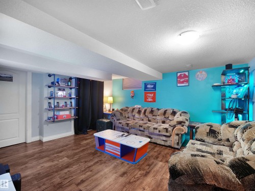 Wood-finish flooring, recessed lighting, built-in shelving, and a white interior door - 13338 131 Street Nw, Edmonton, AB 