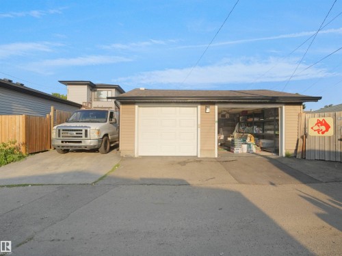 Detached two-car garage with a single white overhead door and an open bay - 13338 131 Street Nw, Edmonton, AB 