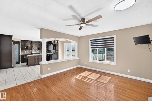 Hardwood flooring, ceiling fan, and recessed lighting in the living area - 4711 152 Avenue Nw, Edmonton, AB 