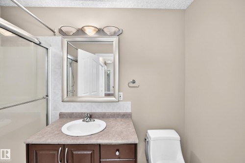 Vanity with an integrated sink, polished chrome faucet, and storage cabinetry - 4711 152 Avenue Nw, Edmonton, AB 