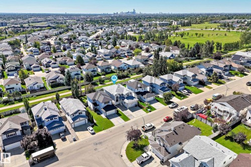 Aerial perspective of a residential neighborhood with a distant cityscape - 4711 152 Avenue Nw, Edmonton, AB 
