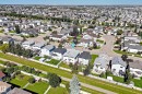 Residential neighborhood with a grid pattern, featuring multiple single-family homes with pitched roofs, individual driveways, and landscaped yards - 4711 152 Avenue Nw, Edmonton, AB 