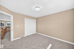 Wall-to-wall carpeting, neutral wall color, and a built-in closet with bifold doors - 
