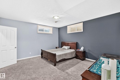 Carpeted flooring, recessed windows, two-tone wall paint, white interior door, ceiling-mounted lighting - 4711 152 Avenue Nw, Edmonton, AB 