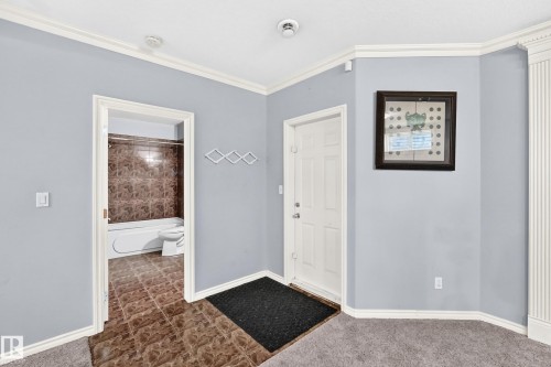 White paneled entry door, crown molding, and light gray wall paint - 4711 152 Avenue Nw, Edmonton, AB 