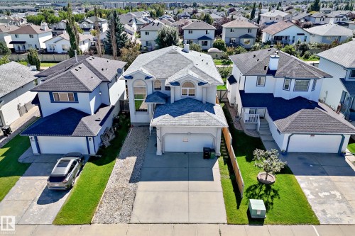 Two-story residence with a light-colored exterior and dark-shingled roofing - 4711 152 Avenue Nw, Edmonton, AB 