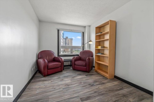 Hardwood-style flooring and a large window with multiple panes - #906 12303 Jasper Av Nw, Edmonton, AB 
