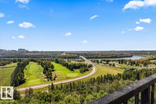 Expansive urban landscape featuring a wide river, a golf course with green fairways, dense treelines, and a multi-lane bridge - #906 12303 Jasper Av Nw, Edmonton, AB 