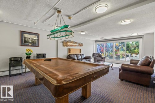 Recreational room with carpet flooring, track lighting, and large sliding glass doors - #906 12303 Jasper Av Nw, Edmonton, AB 