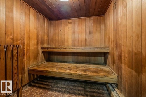 Wood-paneled interior featuring integrated benches - #906 12303 Jasper Av Nw, Edmonton, AB 