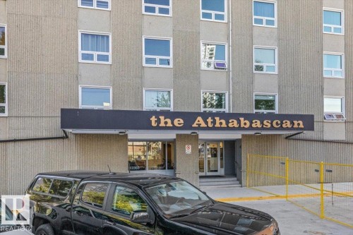 Building exterior with textured facade and multiple window units - #906 12303 Jasper Av Nw, Edmonton, AB 