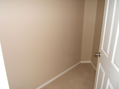 Wall-to-wall carpeting with light beige walls and white trim - 4825 59 Avenue, Vegreville, AB 