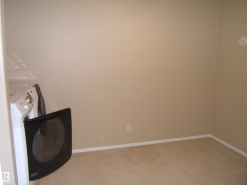 Carpeted flooring, neutral wall color, and a wall outlet - 4825 59 Avenue, Vegreville, AB 