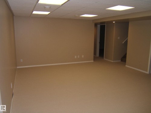 Open concept recreation area with carpet flooring, recessed lighting, and a drop ceiling - 4825 59 Avenue, Vegreville, AB 