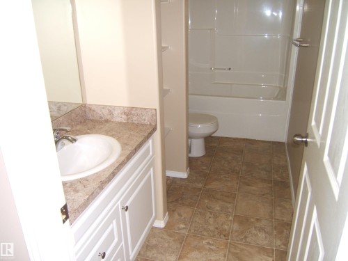 Vanity with an integrated sink and patterned countertop - 4825 59 Avenue, Vegreville, AB 
