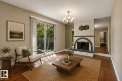 Bright living room with hardwood flooring and natural light from French doors opening to outdoor space - 