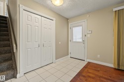 Welcoming foyer featuring ceramic tile flooring, warm neutral wall finishes, and abundant natural light from the entry door - 