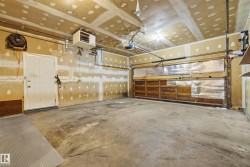 Single overhead garage door, concrete flooring, overhead lighting, side entry door, wall-mounted heater - 