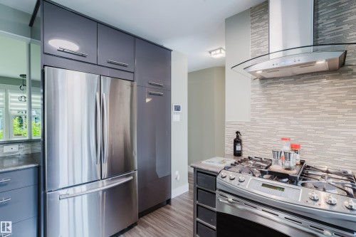 Contemporary kitchen featuring stainless steel appliances, including a French door refrigerator and a gas range - 14814 104 Avenue Nw, Edmonton, AB - Indoor Photo Showing Kitchen With Upgraded Kitchen