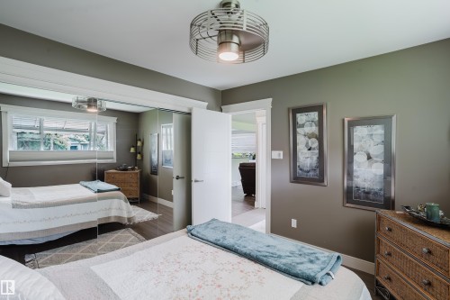 Room featuring hardwood-finish flooring, a contemporary ceiling fan, and painted walls - 14814 104 Avenue Nw, Edmonton, AB - Indoor Photo Showing Bedroom