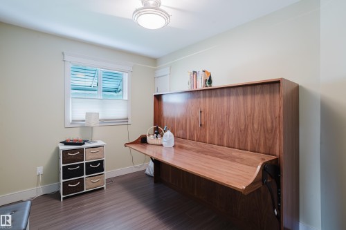 Integrated wood-finish wall unit featuring a fold-down desk - 14814 104 Avenue Nw, Edmonton, AB - Indoor
