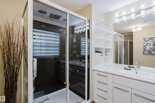 Modern bathroom featuring a glass-enclosed shower with integrated fixtures - 14814 104 Avenue Nw, Edmonton, AB - Indoor Photo Showing Bathroom