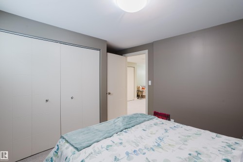Bedroom featuring neutral gray wall paint, white trim, and light-colored carpeting - 14814 104 Avenue Nw, Edmonton, AB - Indoor Photo Showing Bedroom