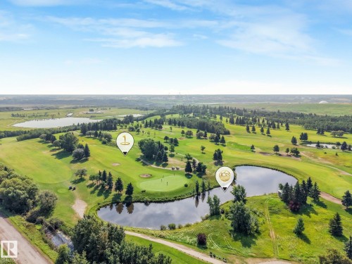 Expansive golf course setting featuring multiple greens, mature trees, and natural water features - 511 157 Avenue Ne, Edmonton, AB 