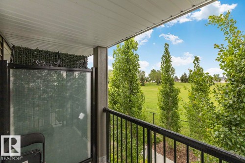 Balcony featuring a black metal railing and a partial privacy screen - #22 3025 151 Av Nw, Edmonton, AB - Outdoor With Exterior