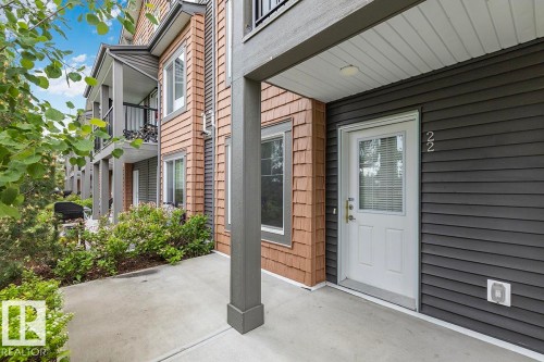 Building exterior featuring dark gray horizontal siding and light brown shake siding - #22 3025 151 Av Nw, Edmonton, AB - Outdoor