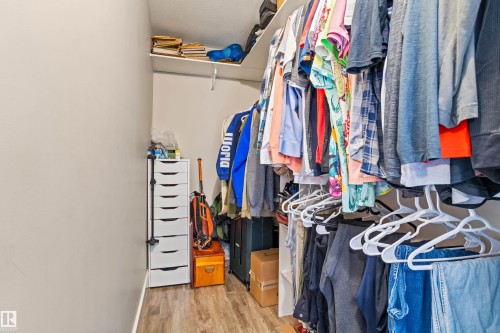 Custom closet system featuring wood-finish flooring and integrated shelving - 4927 57 Avenue, Cold Lake, AB 
