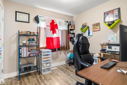 Light-toned wall paint with wood-finish flooring - 4927 57 Avenue, Cold Lake, AB 