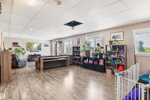 Wood-finish flooring with a drop ceiling featuring recessed lighting - 4927 57 Avenue, Cold Lake, AB 