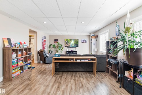 Expansive interior with wood-finish flooring, recessed lighting, and white window blinds - 4927 57 Avenue, Cold Lake, AB 