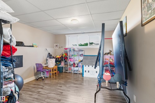 Recessed ceiling, neutral wall paint, wood-finish flooring, and white window frames - 4927 57 Avenue, Cold Lake, AB 