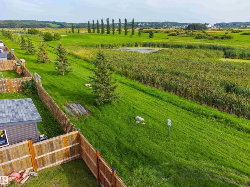 Expansive green space featuring a natural water body and mature greenery - 4927 57 Avenue, Cold Lake, AB 