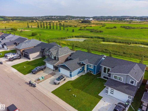 Modern residential structures featuring pitched roofs, attached garages, and manicured lawns - 4927 57 Avenue, Cold Lake, AB 