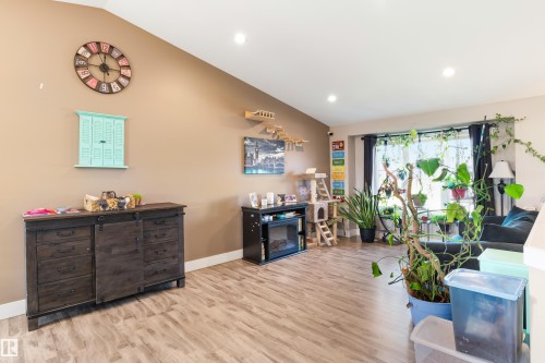 Vaulted ceiling, recessed lighting, wood-finish flooring, a large window, and light-toned wall paint - 4927 57 Avenue, Cold Lake, AB 