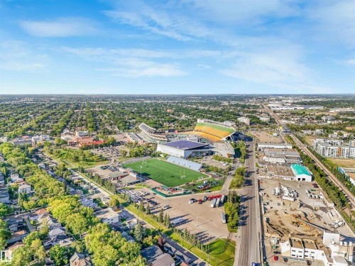 Expansive urban landscape with extensive tree canopy, multiple commercial structures, and a prominent stadium - 9347 105 Avenue Nw, Edmonton, AB 